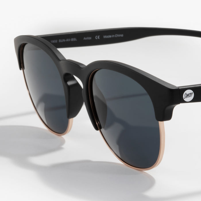Black sunglasses with dark lenses on a white background