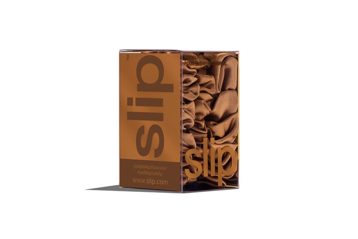 A set of three copper slipsilk scrunchies, including two midi and one large, in branded packaging on a white background.
