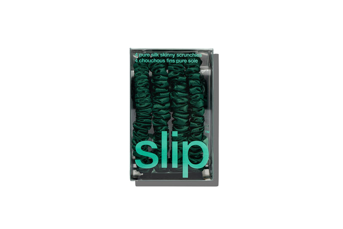 Green skinny silk scrunchies in green slip packaging on a white background