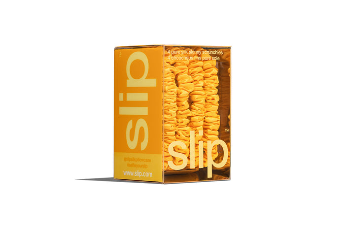 Yellow slip skinny scrunchies in yellow packaging on a white background
