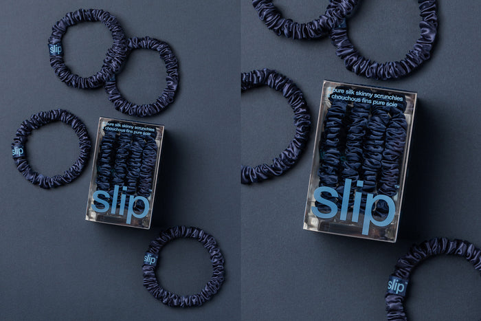 Navy silk skinny scrunchies and slip packaging on a navy blue background