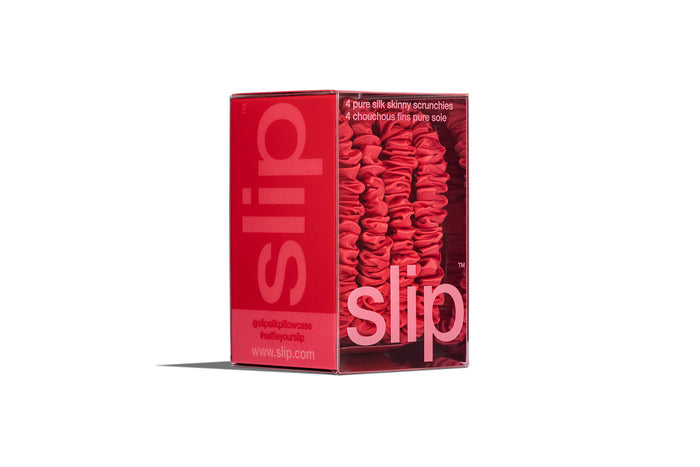 Red skinny silk scrunchies in red slip packaging on a white background