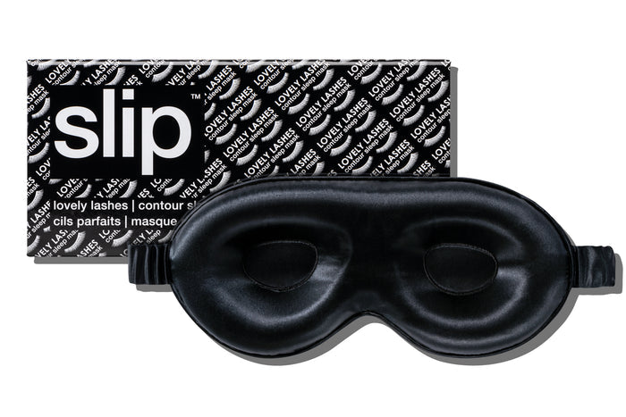 A black slip silk contour sleep mask with the brand name 'slip' visible on the packaging. Designed to protect delicate eyelash extensions.