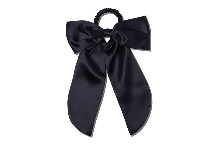 Black silk hair bow on a white background.