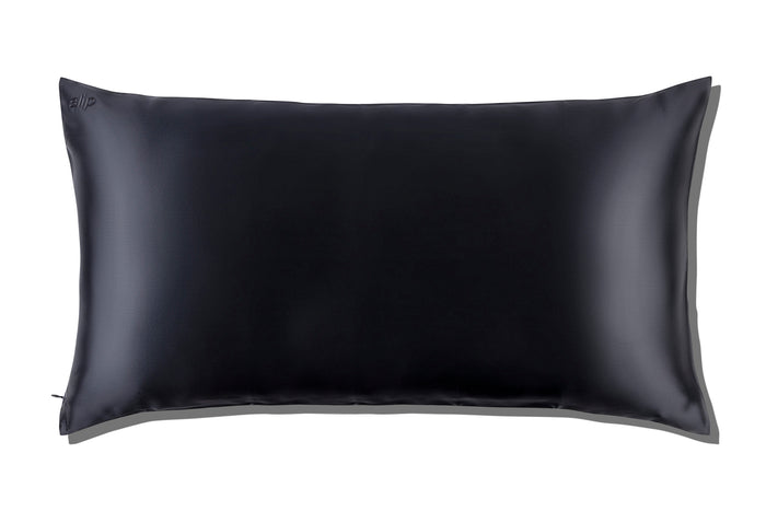 A black slip silk king pillowcase on a white background.
