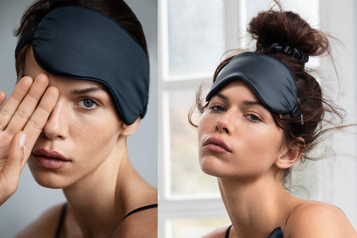 A woman wearing a black slip silk sleep mask.