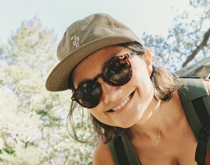 STORY girl looking down at camera wearing sunski friendly cactus hat