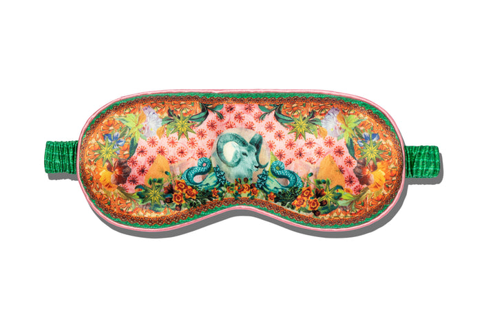 A floral patterned slip silk sleep mask with Capricorn star sign details.