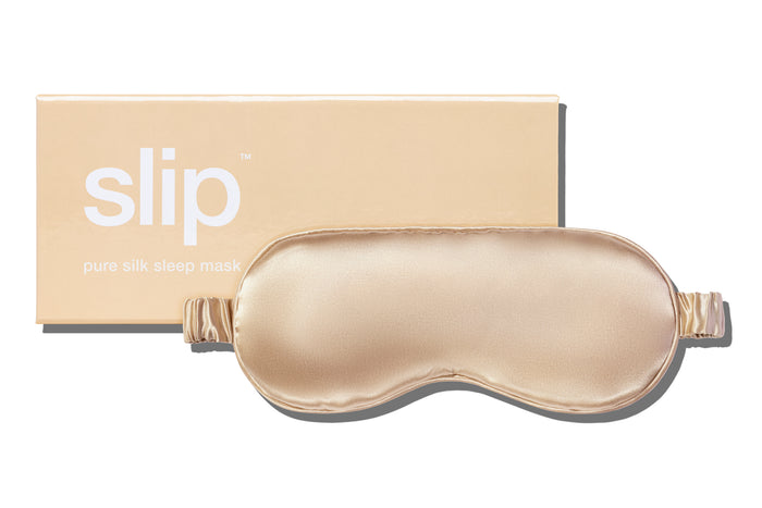 A caramel slip silk sleep mask with branded box on a white background.