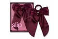 Burgundy Maroon Crimson silk hair bow with slip packaging on a white background.