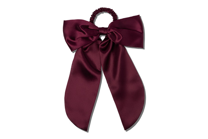 Maroon hair bow on a white background.
