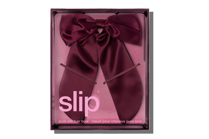 Maroon crimson colored hair bow in packaging with 'slip' branding on a white background.