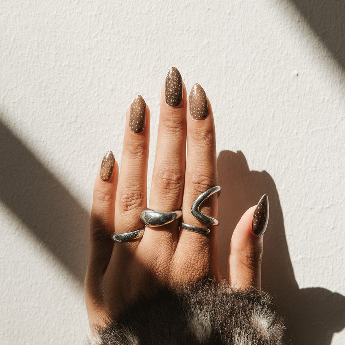 Close-up of Deer Me gel nail stickers by Maniac Nails, warm brown nails with a soft speckle print