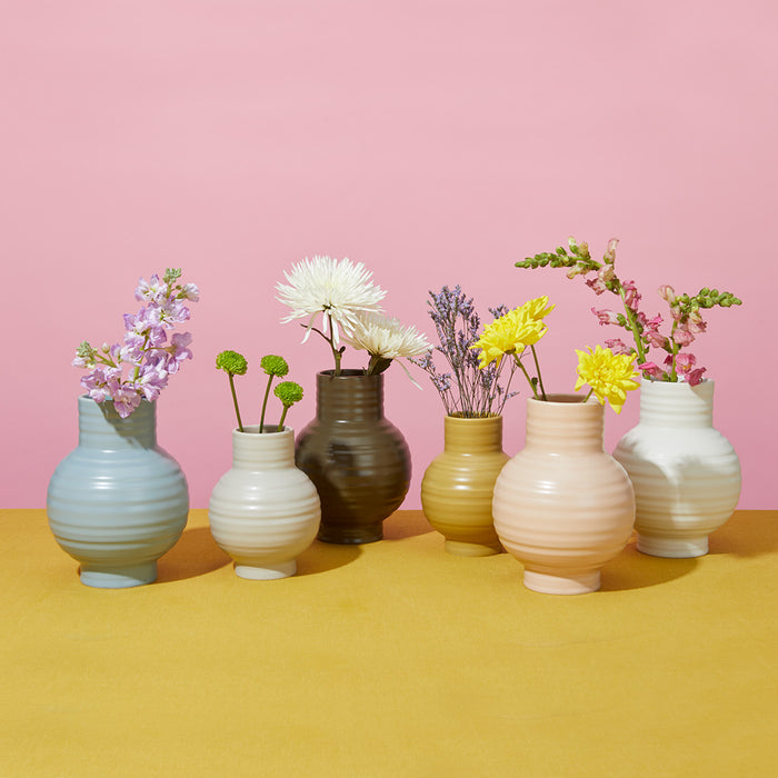 Essential Ceramic Vase in various colors and sizes with flowers.