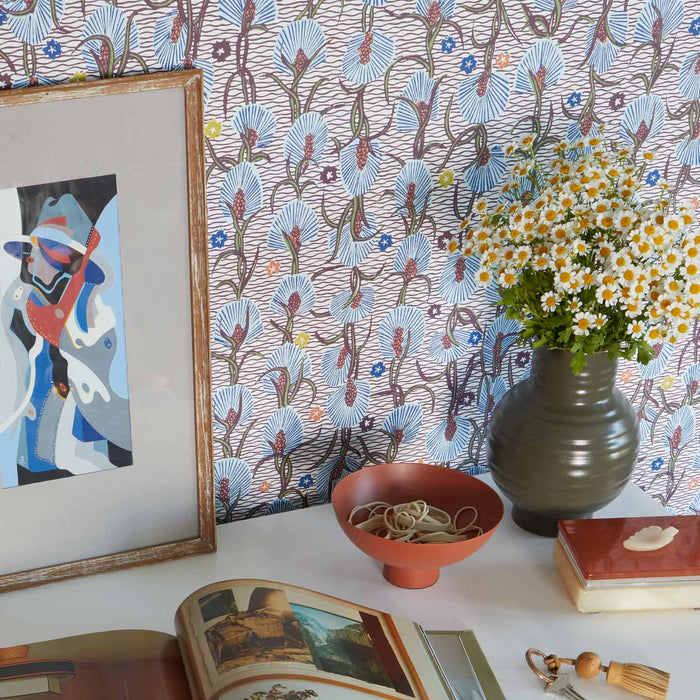 Essential Ceramic Vase in Olive with flowers on desk with wallpaper.
