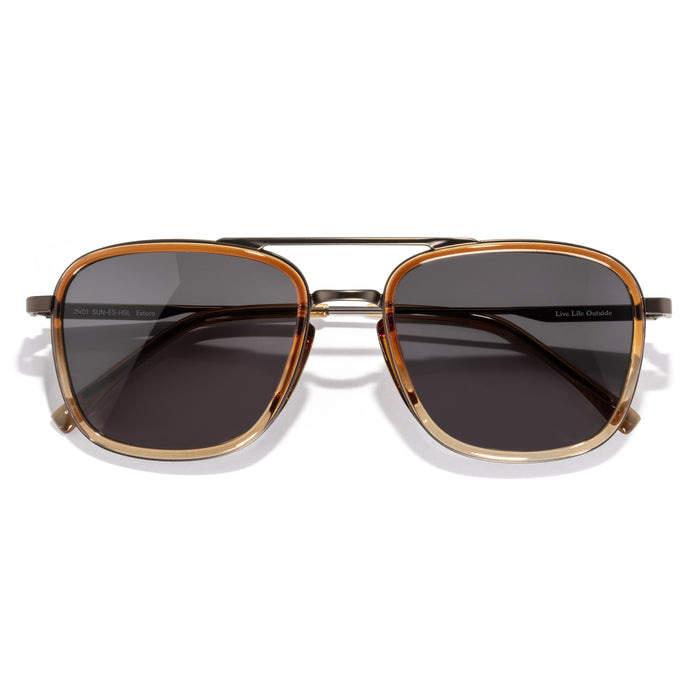 Sunglasses with gold frame and dark lenses on a white background