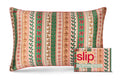 A slip silk pillowcase with a festive vertical knit-style holiday pattern in green, red, beige, and cream, shown next to its matching branded slipcase. The pattern features gingerbread men, holly, bows, and snowflakes.