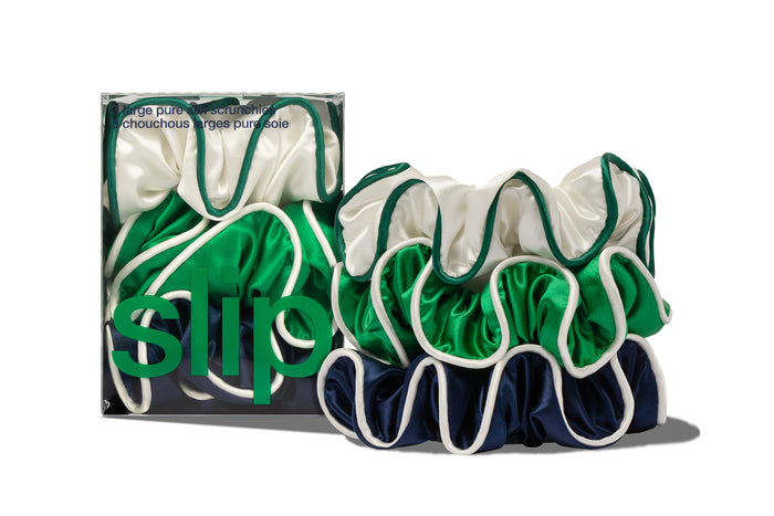 Set of green, navy and white slip large silk hair scrunchies with packaging on a white background