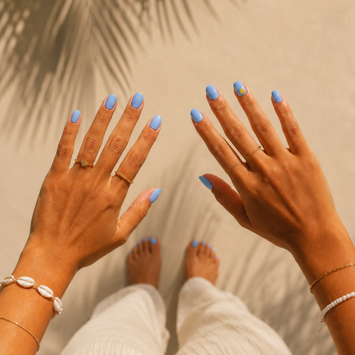 Good Vibes Only nail art by Maniac Nails, soft sky blue gel nail stickers with smiley face detail on a hand