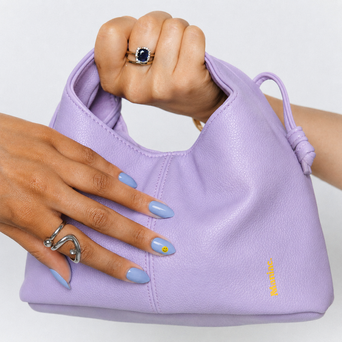 Good Vibes Only nail art by Maniac Nails, soft sky blue gel nail stickers with smiley face detail on a hand