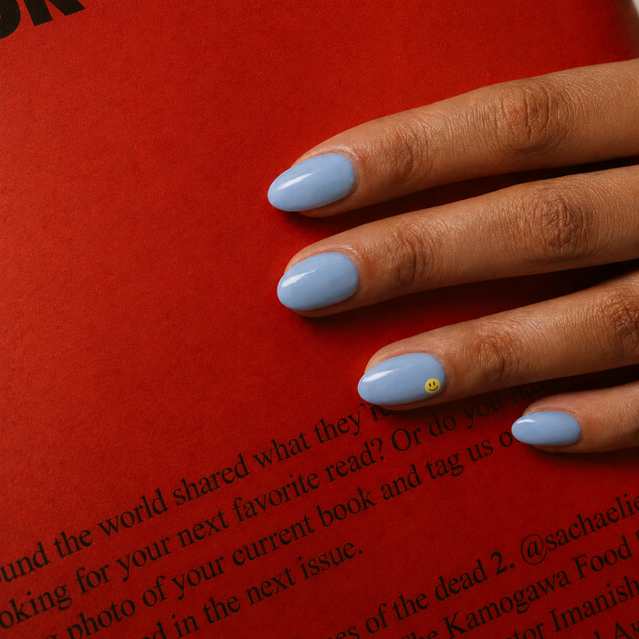 Good Vibes Only nail art by Maniac Nails, soft sky blue gel nail stickers with smiley face detail on a hand