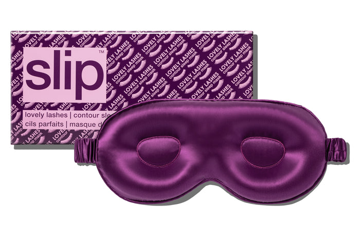 A dark purple slip silk contour sleep mask designed to protect delicate eyelash extensions, with the brand name 'slip' visible on the packaging.