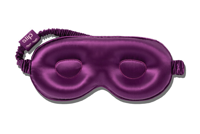 A dark purple slip silk contour sleep mask designed to protect delicate eyelash extensions, on white background.