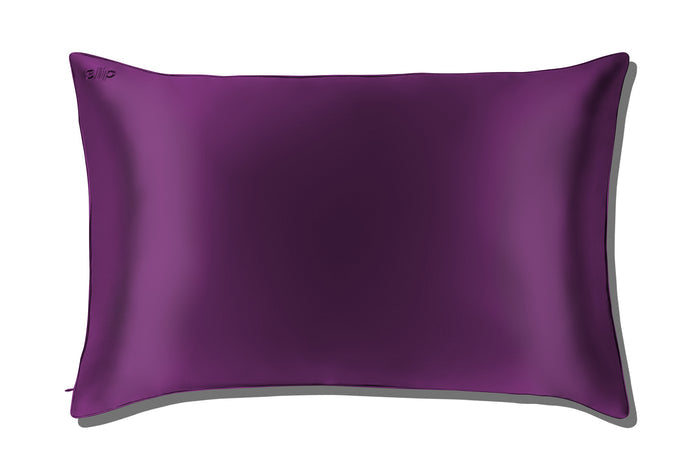 A dark purple slip silk queen pillowcase on a white background.