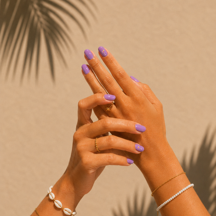 Happy Hour lilac purple gel nail stickers by Maniac Nails, intertwined hands against palm shadow