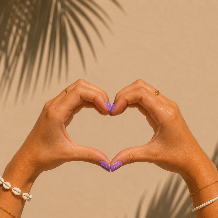 Happy Hour lilac purple gel nail stickers by Maniac Nails, hands forming a heart shape in golden sunlight