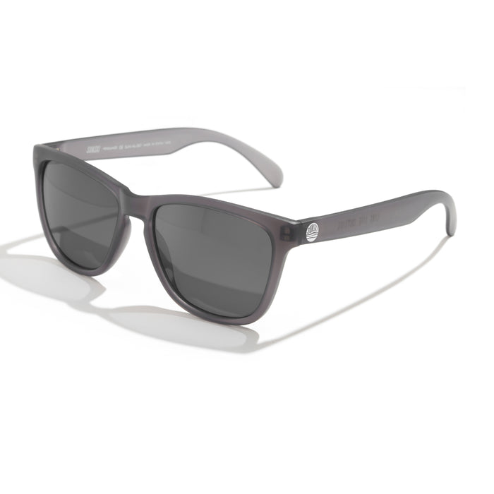 Sunglasses with tortoiseshell frame and dark lenses on a white background