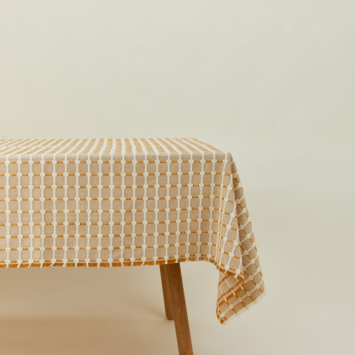 Dove and Donkey hopsack tablecloth in honey on table