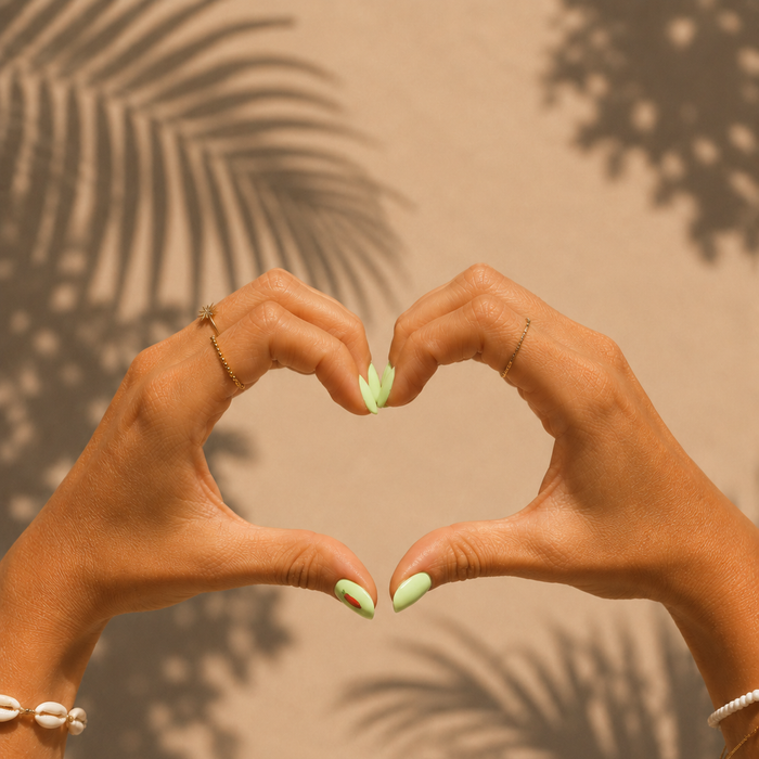 Hot & Spicy pastel green gel nail stickers by Maniac Nails, hands forming a heart shape