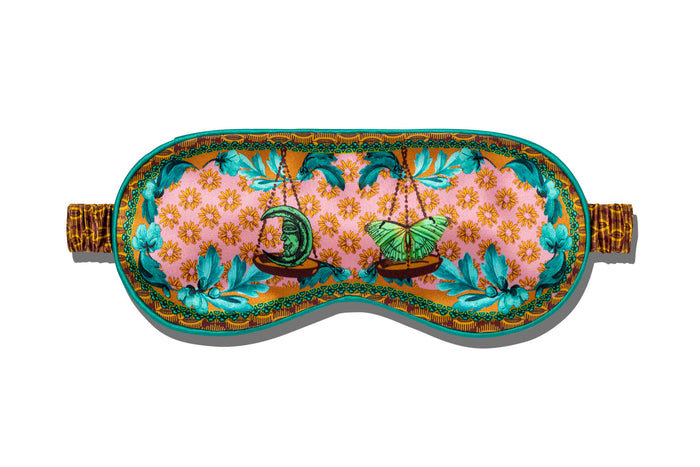 A floral patterned with scale graphic on a slip silk sleep mask for the Libra star sign.