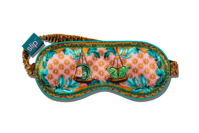 A floral patterned with scale graphic on a slip silk sleep mask for the Libra star sign.
