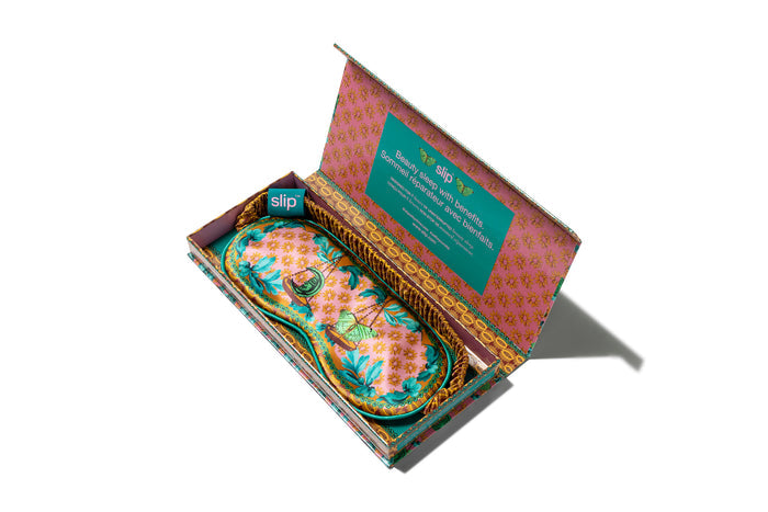 A floral patterned with scale graphic slip silk sleep mask for the Libra star sign. Displayed in open branded box on a white background.