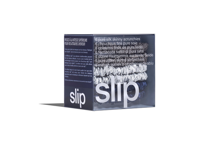 A set of six slip silk skinny scrunchies in navy, silver, and charcoal, displayed in branded packaging on a white background.
