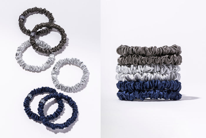 A flatlay and stacked shot of slip silk skinny scrunchies in navy, silver, and charcoal, on a white background.