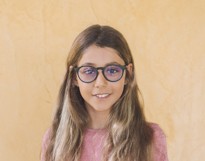 STORY girl wearing sunski mini dipsea bluelight glasses