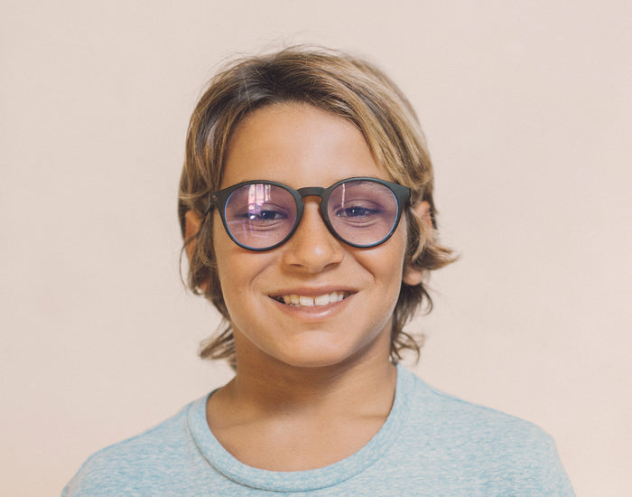 STORY boy wearing sunski mini dipsea bluelight glasses