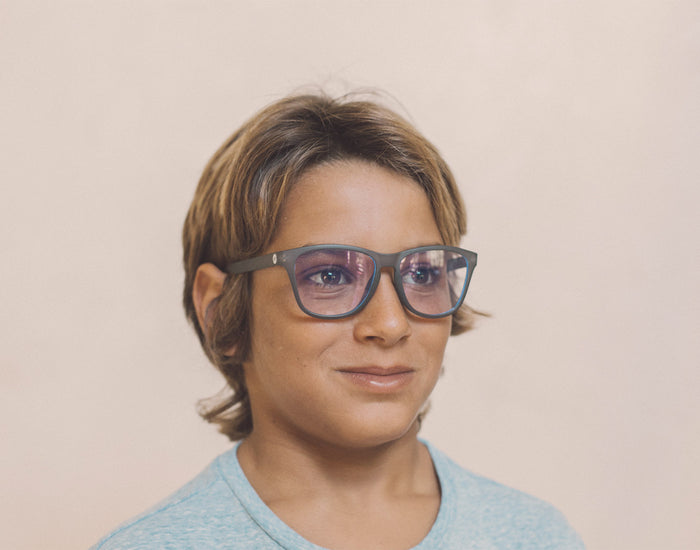 STORY boy wearing sunski mini headland bluelight glasses