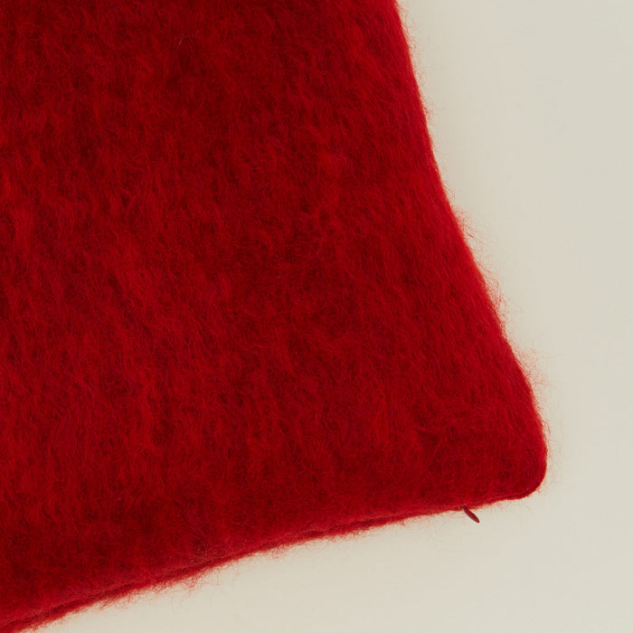 Close up view of mohair pillow in red