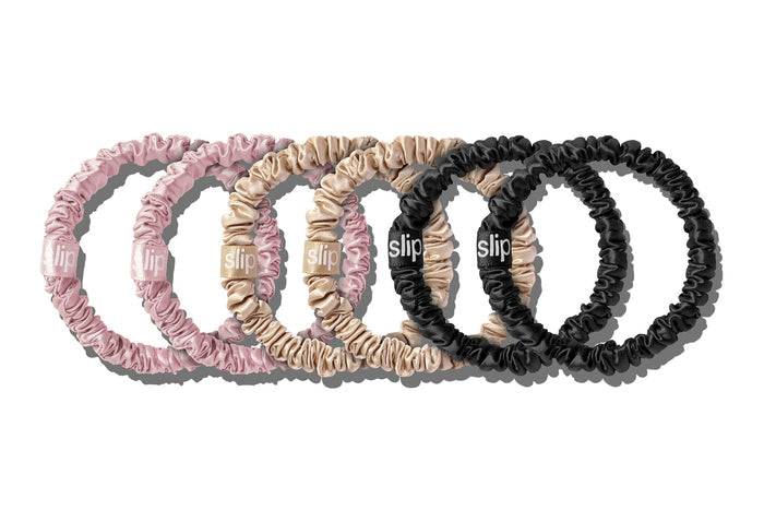 A set of six slip silk skinny scrunchies in pink, caramel, and black on a white background.