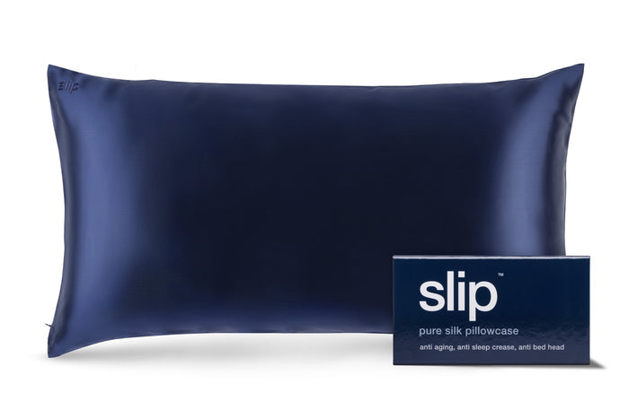 Navy slip silk king pillowcase with branded packaging on a white background.