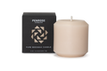 Nude beige beeswax pillar candle next to black Penrose Candles packaging box with geometric logo design