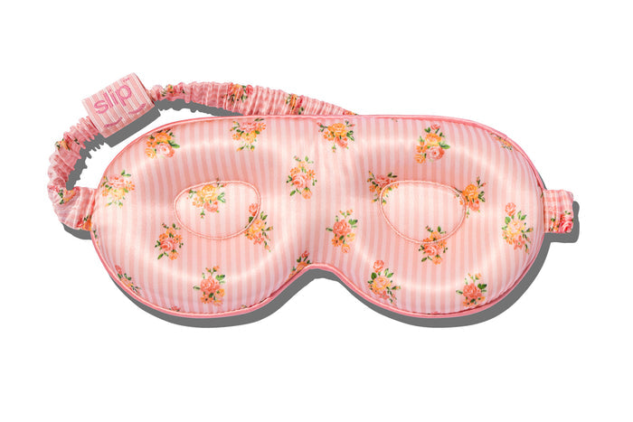 A floral pink stripe slip silk contour sleep mask designed to protect delicate eyelash extensions, on white background.