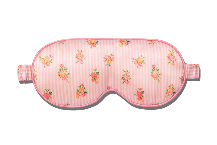A floral pink stripe slip silk contour sleep mask designed to protect delicate eyelash extensions, on white background.