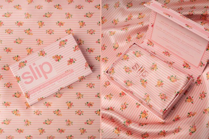 A floral pink and white stripe pattern slip silk queen pillowcase branded packaging box on matching pattern silk background.