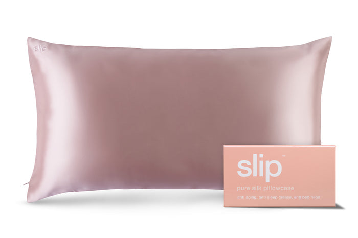 A pink slip silk king pillowcase with branded packaging on a white background.