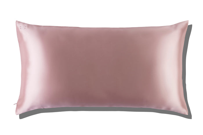 A pink slip silk king pillowcase on a white background.